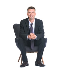 Photo of Handsome young man in suit sitting in armchair on white background