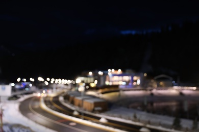 Blurred view of road with snow on sides at night
