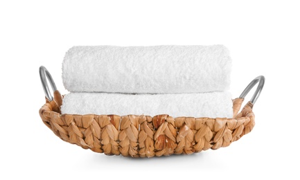 Photo of Wicker tray with clean soft towels on white background