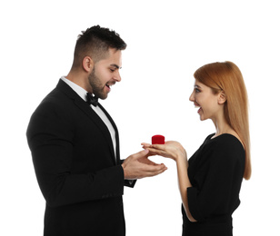 Photo of Young woman with engagement ring making marriage proposal to her boyfriend on white background