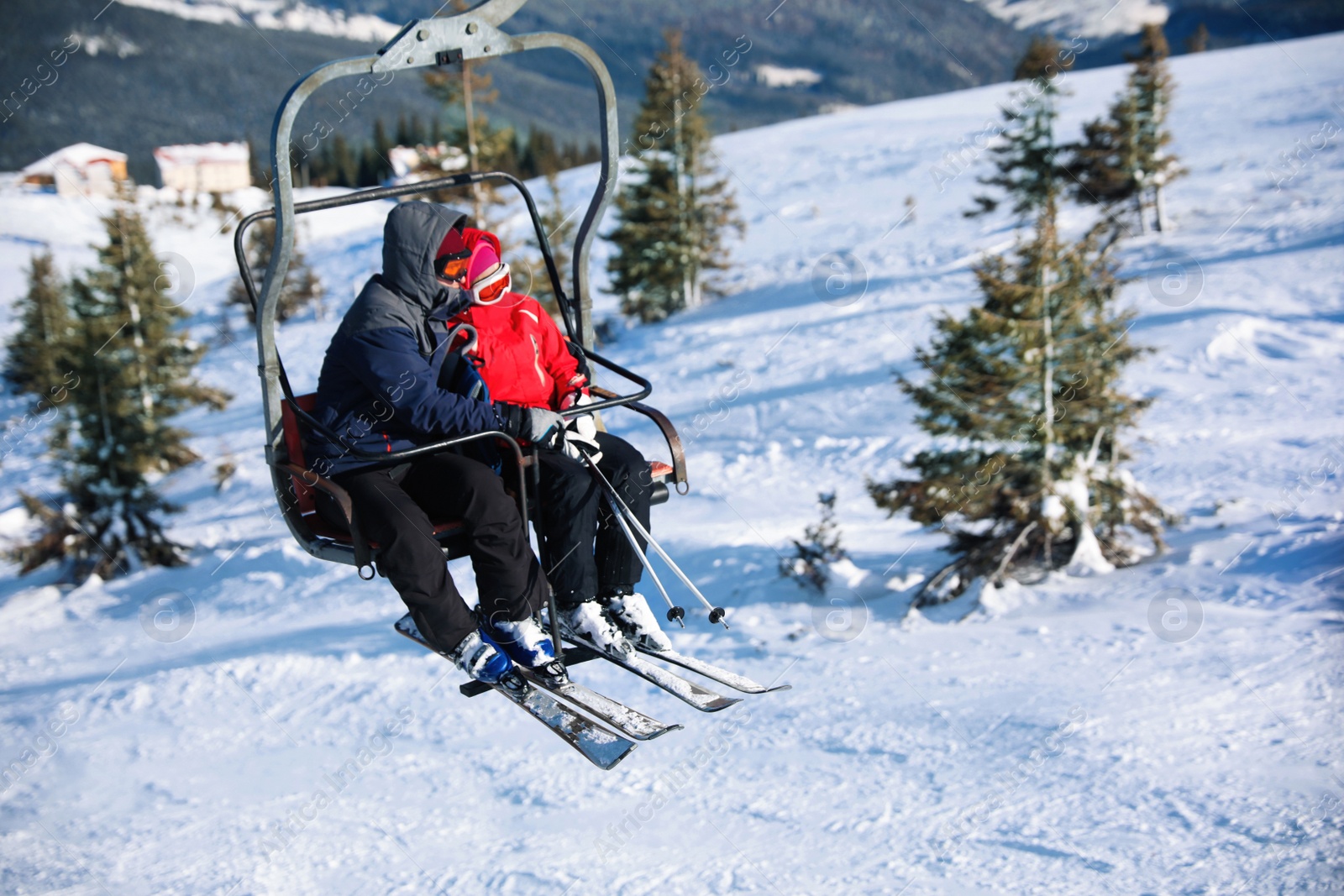 Photo of People using chairlift at mountain ski resort, space for text. Winter vacation