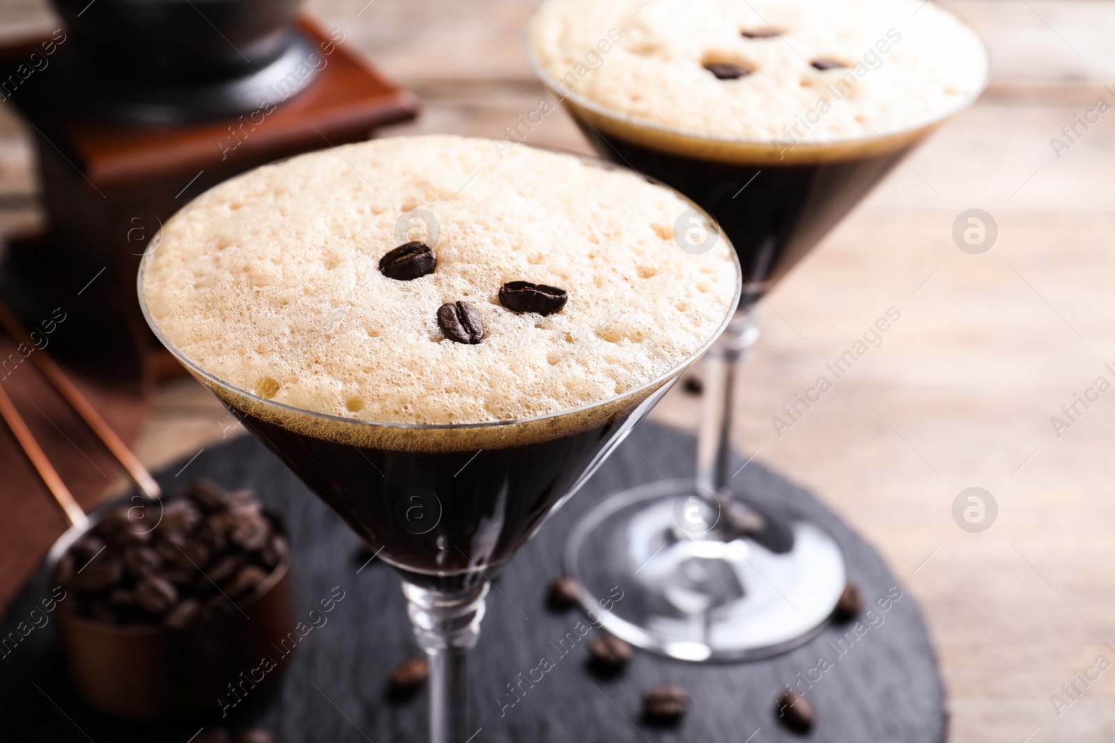 Photo of Glass of fresh coffee cocktail on wooden table, closeup