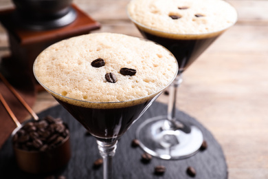 Glass of fresh coffee cocktail on wooden table, closeup