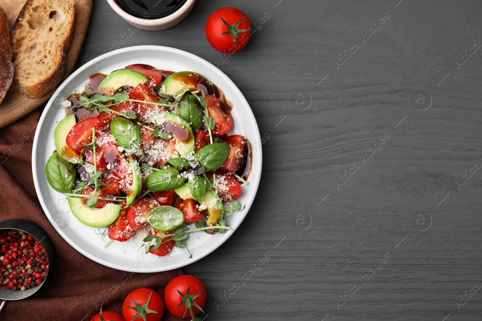 Photo of Tasty salad with balsamic vinegar on grey wooden table, flat lay. Space for text