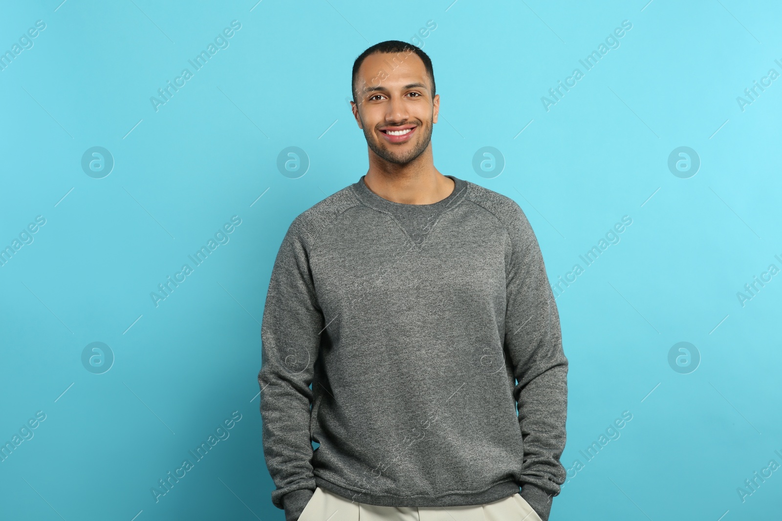 Photo of Portrait of handsome young man on light blue background