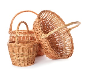 Photo of Three decorative wicker baskets on white background