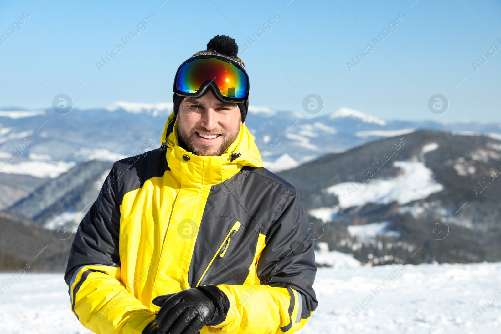 Photo of Happy young man in mountains. Winter vacation