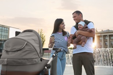 Happy parents walking with their baby outdoors