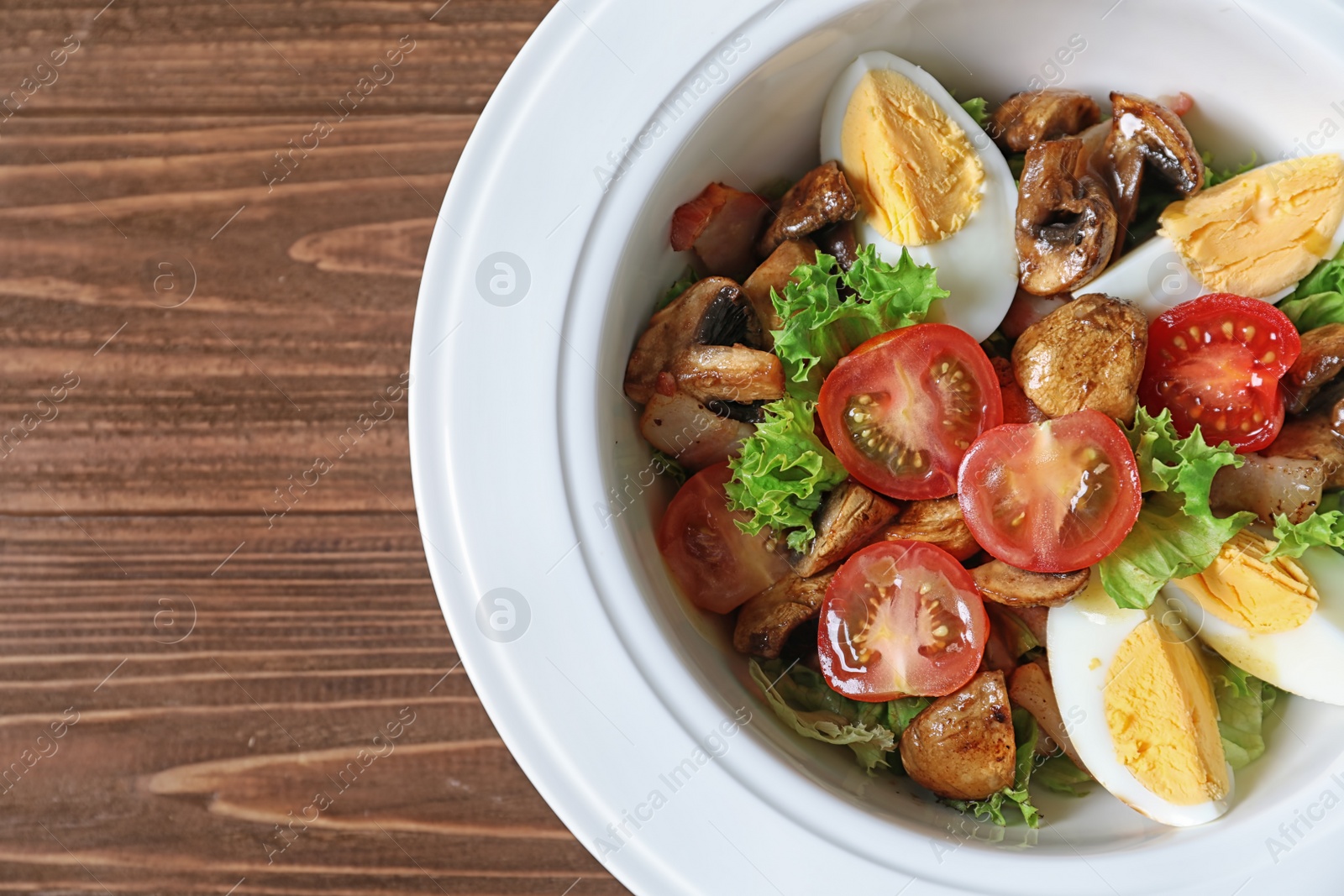 Photo of Plate with delicious fresh salad on table, top view