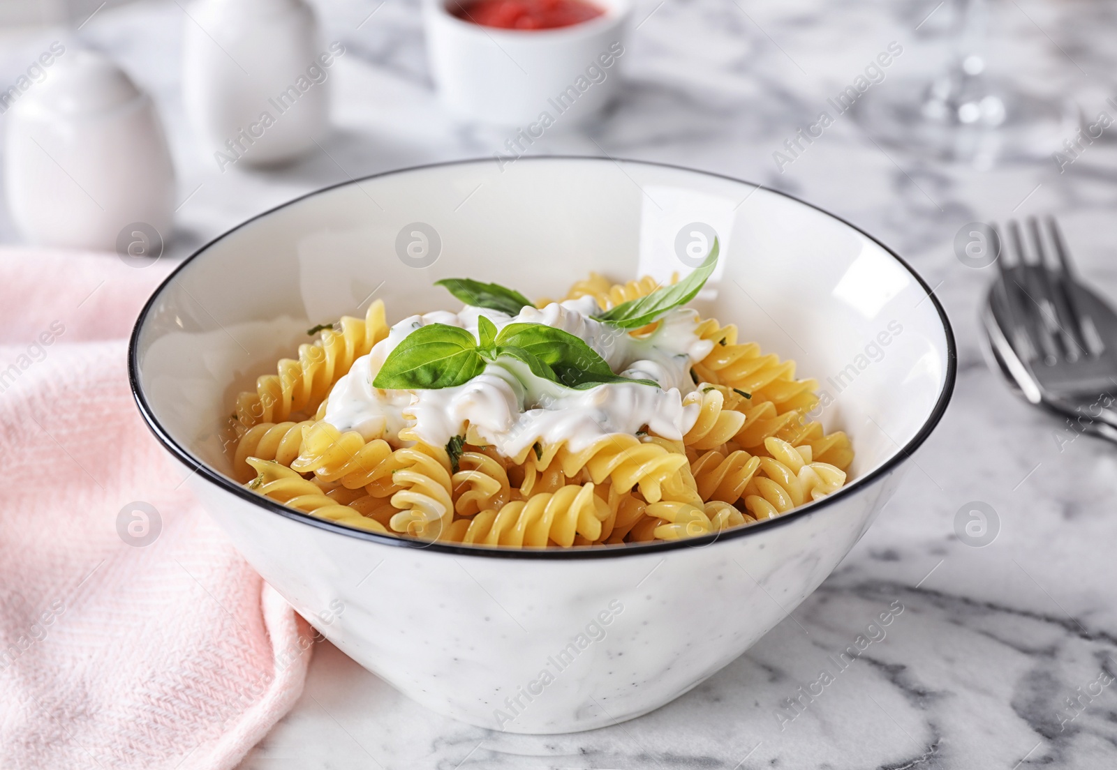 Photo of Delicious pasta with sauce served on white marble table