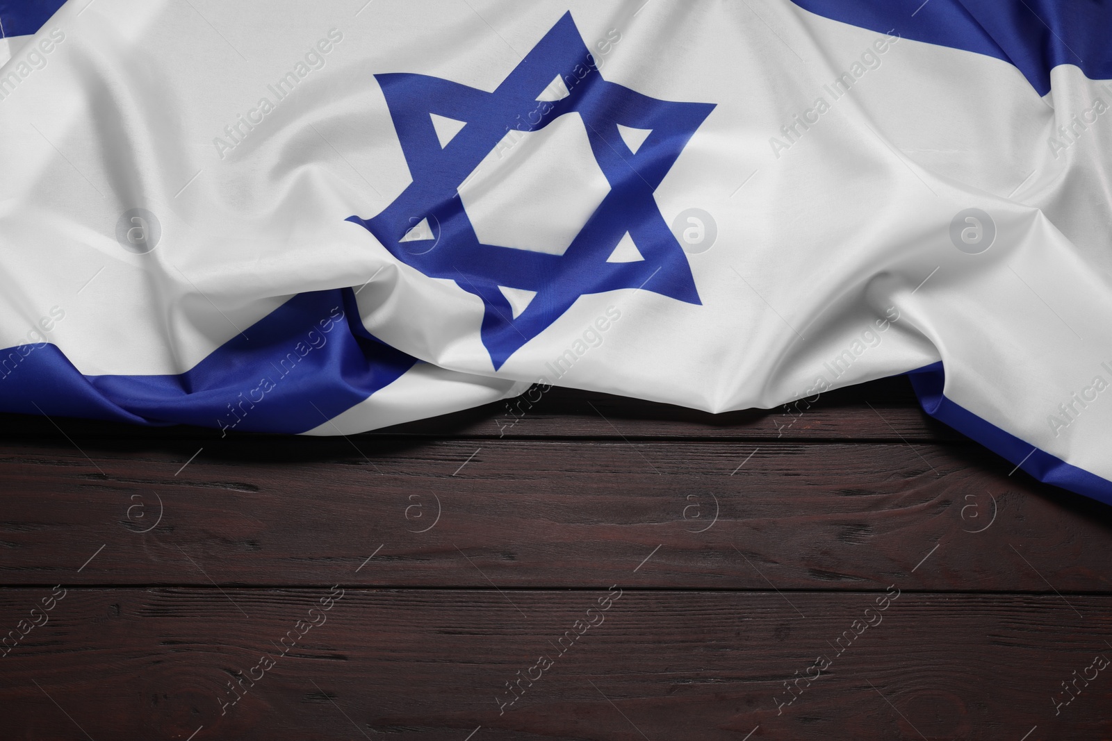 Photo of Flag of Israel on wooden background, top view and space for text. National symbol