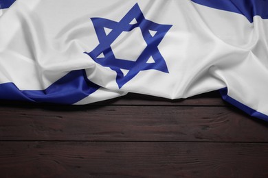 Photo of Flag of Israel on wooden background, top view and space for text. National symbol