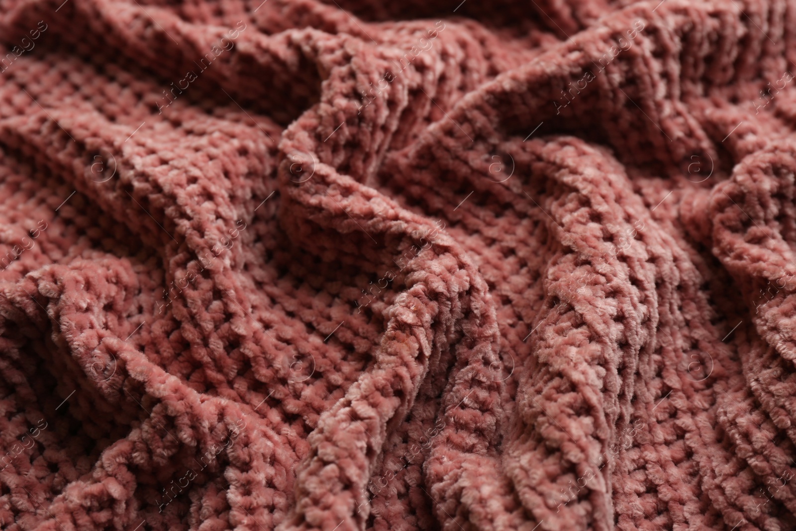 Photo of Beautiful pink knitted fabric as background, closeup