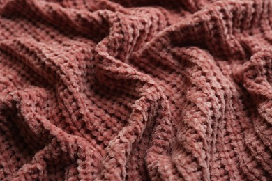 Beautiful pink knitted fabric as background, closeup