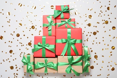 Photo of Christmas tree made with different gift boxes on white background, flat lay