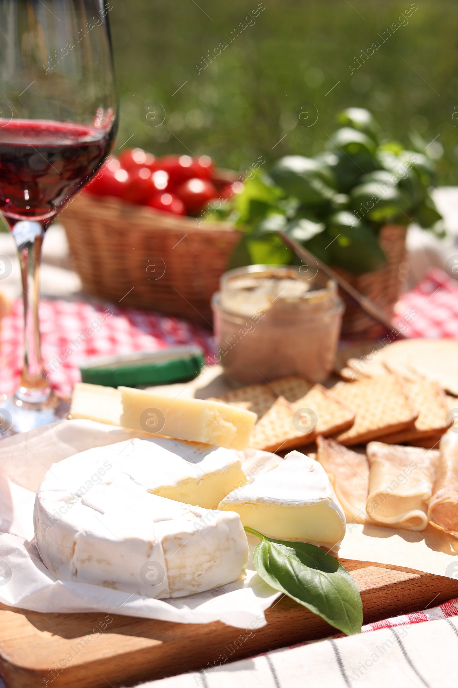 Photo of Blanket with different products outdoors. Summer picnic