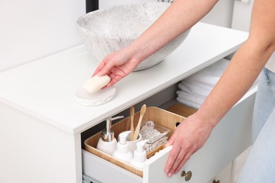 Bath accessories. Woman with soap indoors, closeup