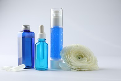 Set of luxury cosmetic products and gentle flower on white background. Space for text