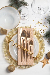 Photo of Elegant table setting on light background, top view. Christmas celebration