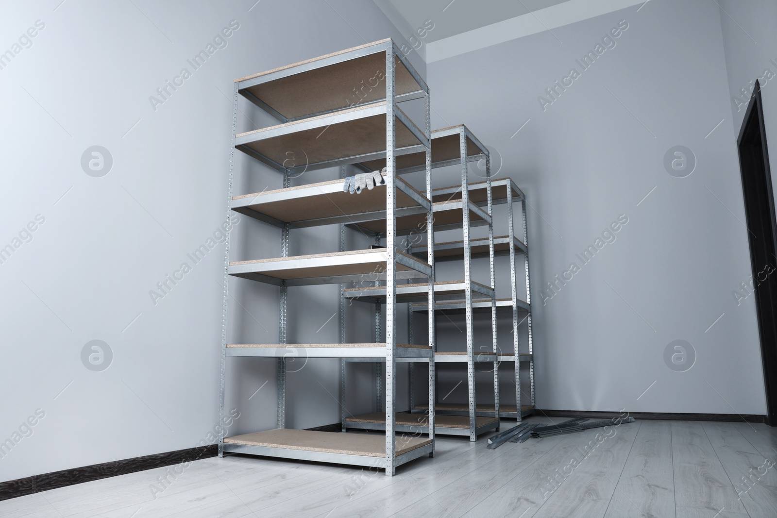 Photo of Office room with white walls and metal storage shelves