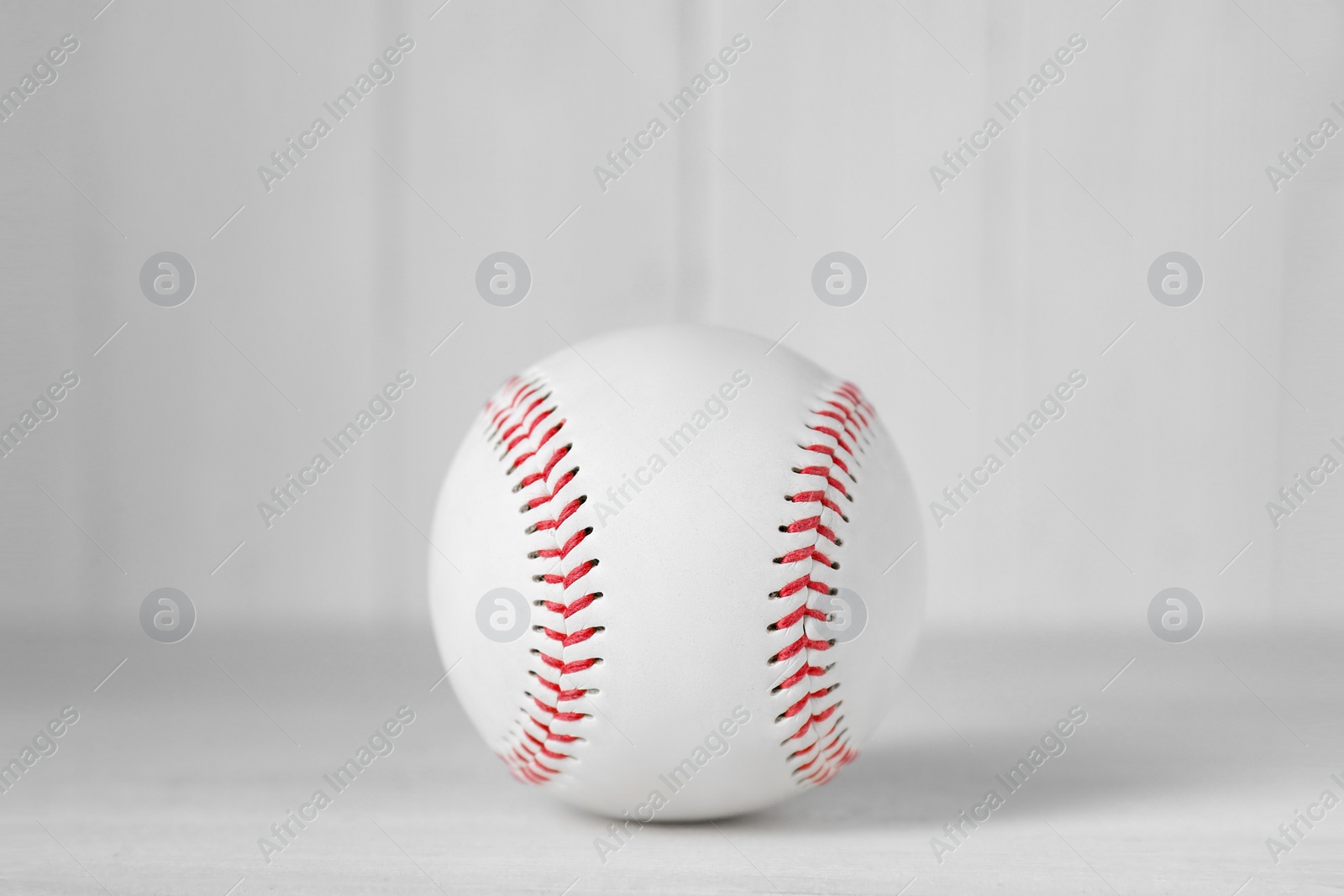 Photo of Baseball ball on white table, closeup. Sportive equipment