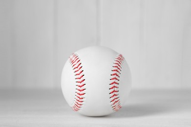 Photo of Baseball ball on white table, closeup. Sportive equipment