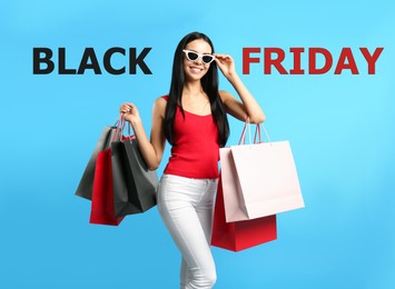 Image of Black Friday Sale. Beautiful young woman with shopping bags on light blue background 