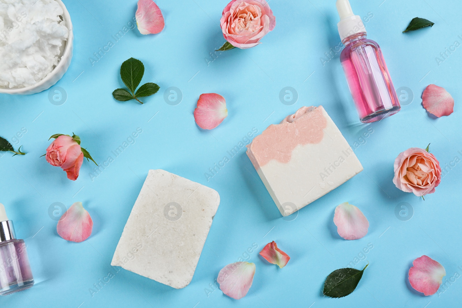 Photo of Flat lay composition with natural handmade soap and ingredients on light blue background