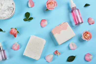 Photo of Flat lay composition with natural handmade soap and ingredients on light blue background