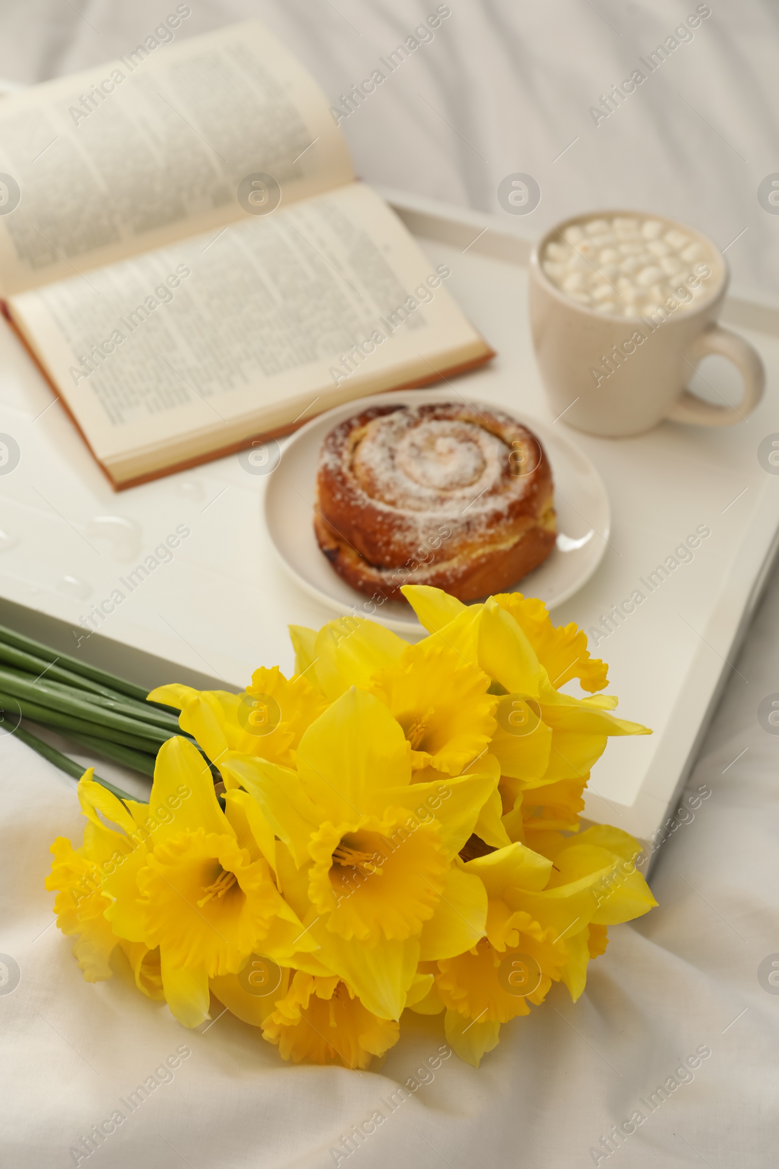 Photo of Bouquet of beautiful daffodils on white bed