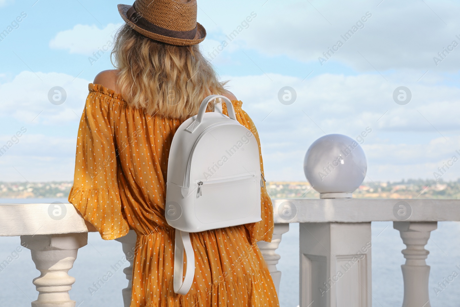 Photo of Young woman with stylish backpack outdoors, back view