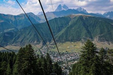 Photo of View of cableway with modern seats in mountains