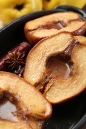 Photo of Tasty baked quinces with spices and honey in dish on table, closeup