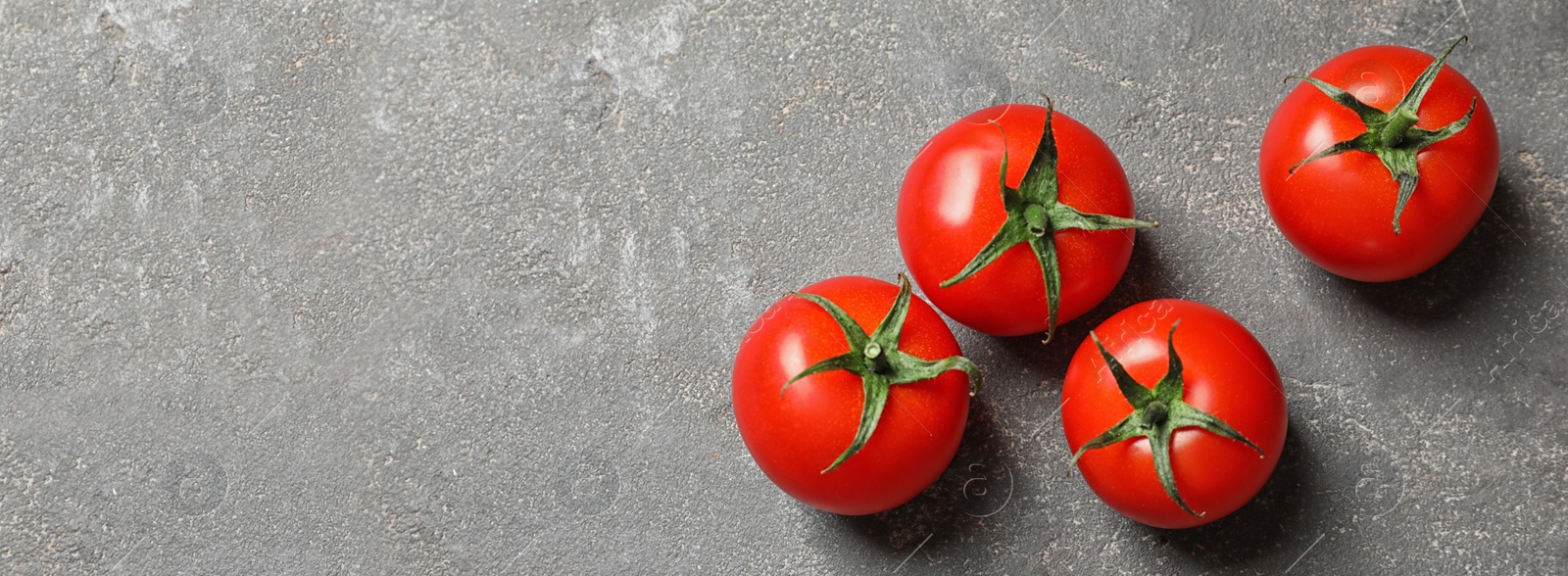 Image of Flat lay composition with fresh cherry tomatoes on grey table, space for text. Banner design 