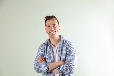 Charming young man on light background