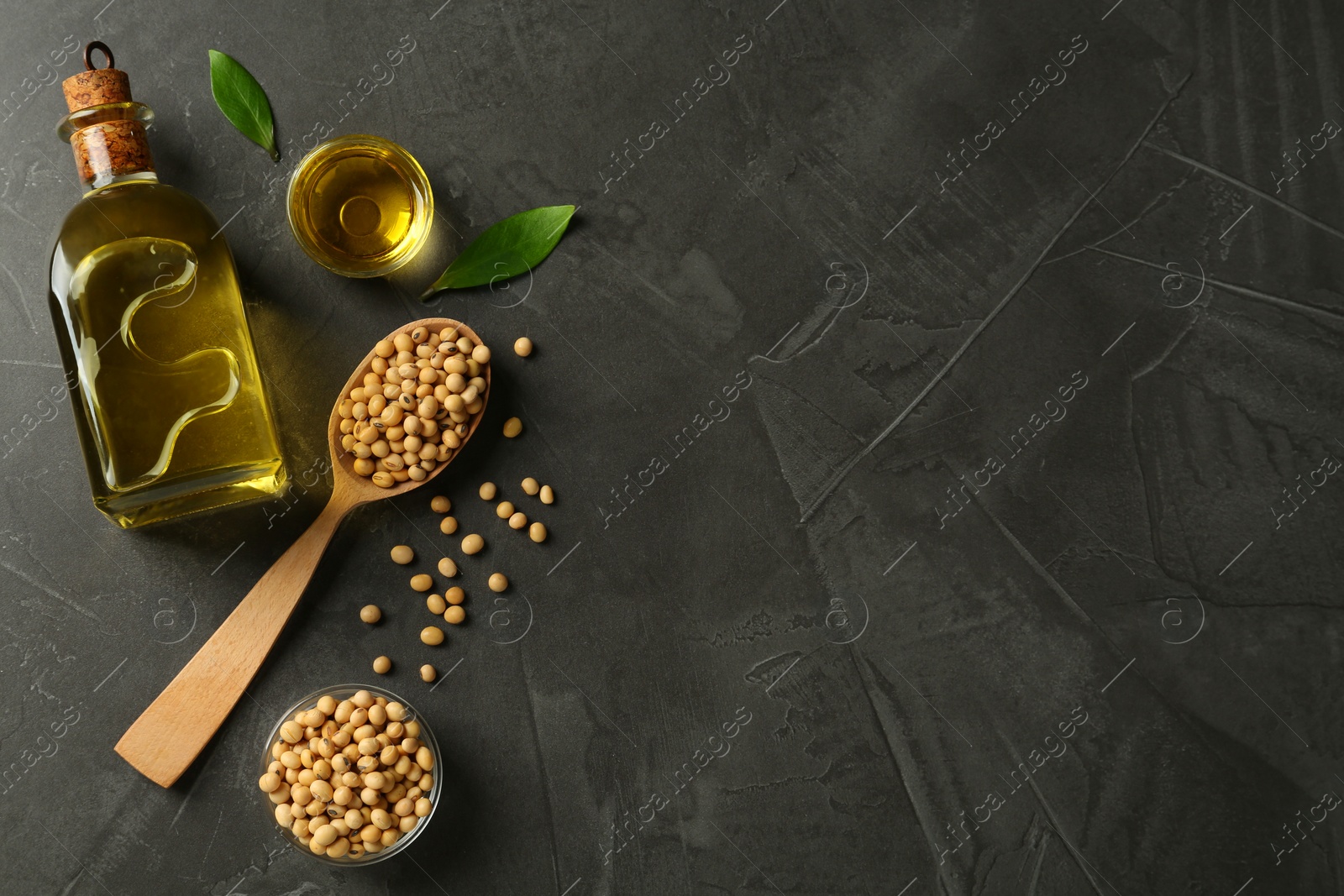 Photo of Flat lay composition with soybean oil on grey table. Space for text