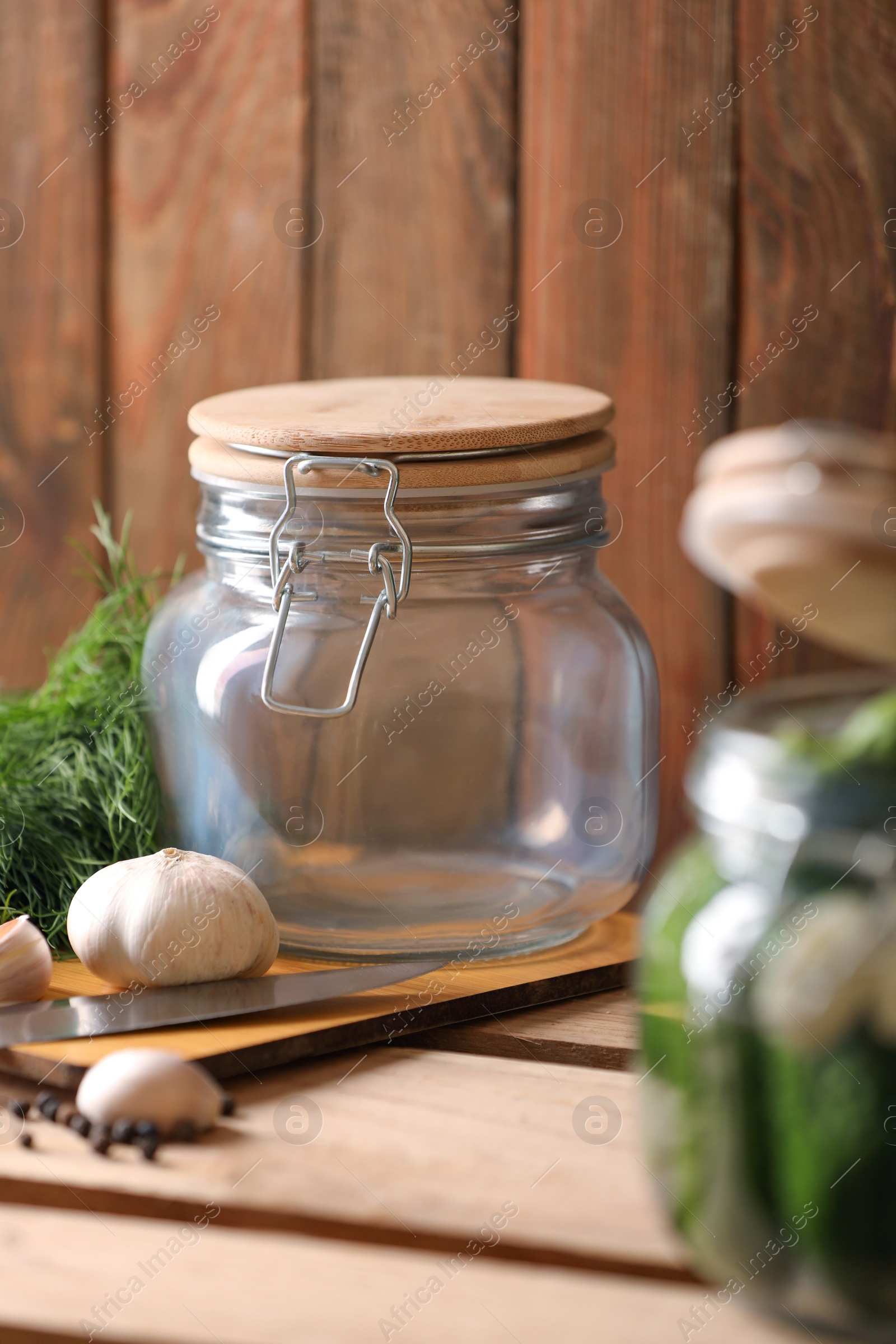 Photo of Empty glass jar on wooden table. Canning vegetable
