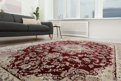 Photo of Cozy room interior with stylish furniture and soft carpet with beautiful pattern