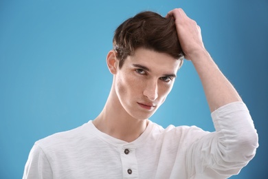 Photo of Portrait of young man with beautiful hair on color background