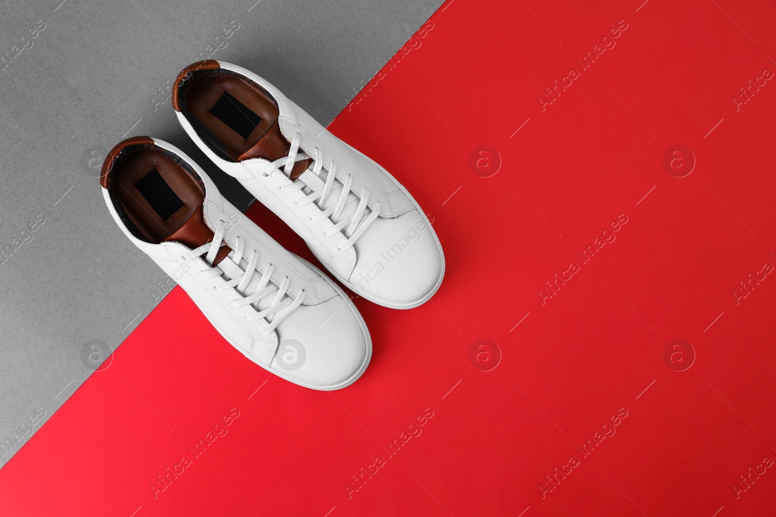 Photo of Pair of stylish sports shoes on color background, flat lay. Space for text