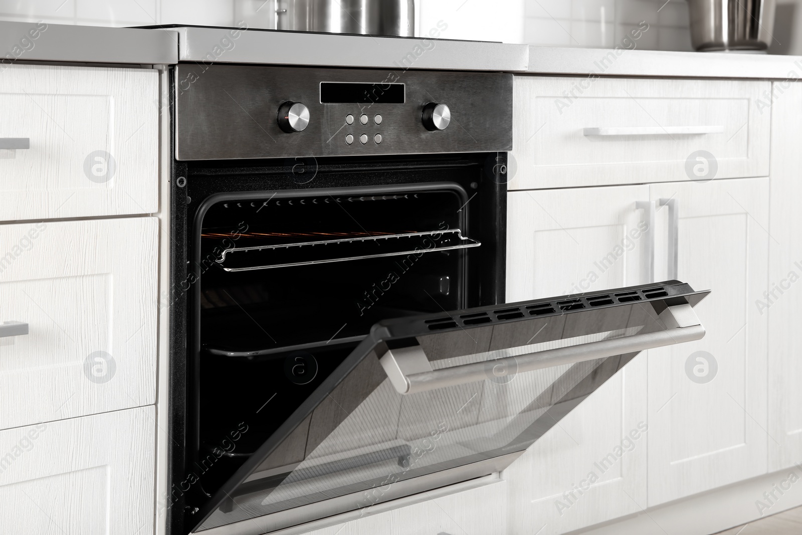 Photo of Open modern oven built in kitchen furniture