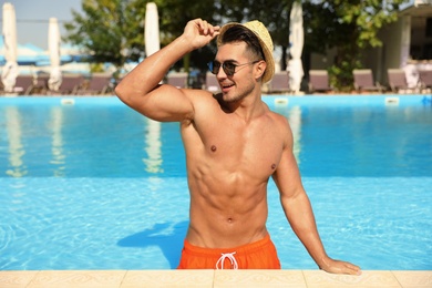 Young man in pool on sunny day