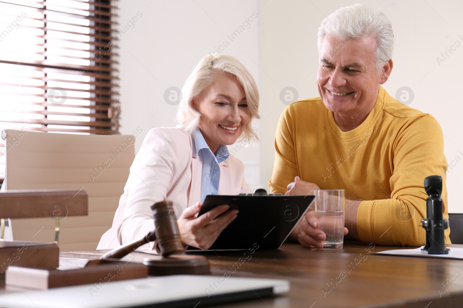 Photo of Female notary working with client in office