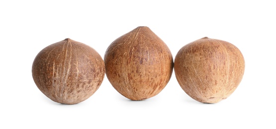 Photo of Ripe whole brown coconuts on white background