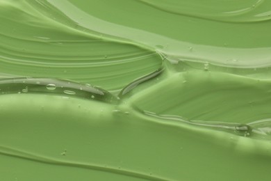 Photo of Clear cosmetic gel on light green background, closeup