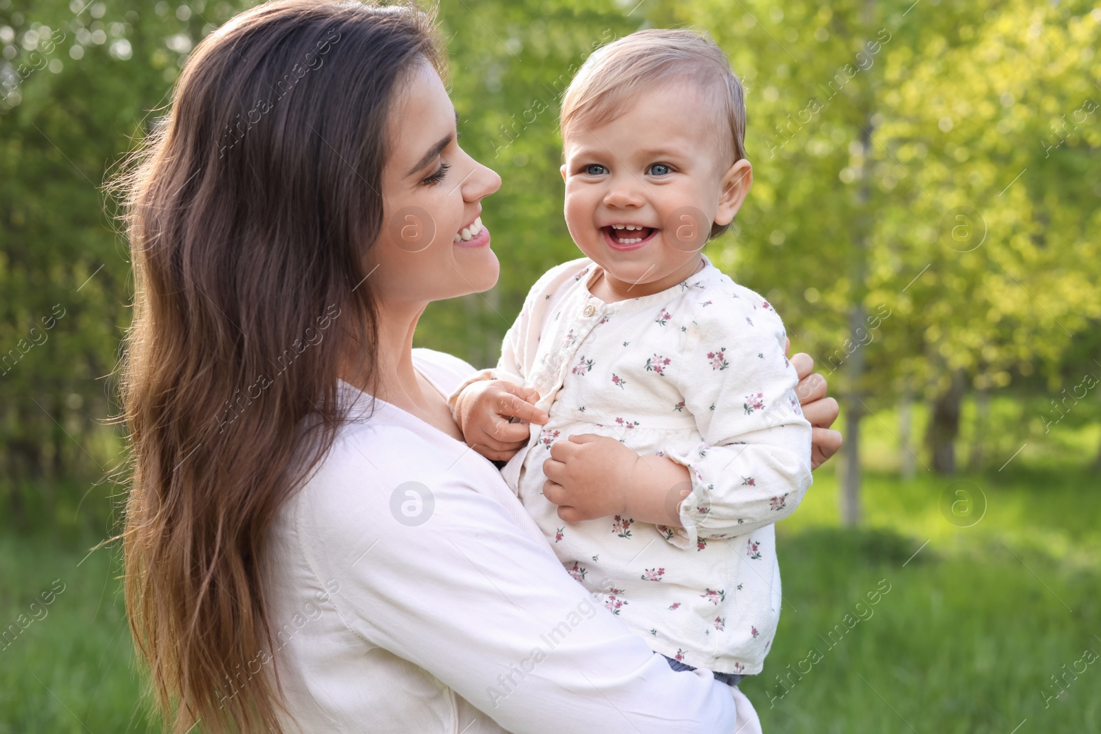 Photo of Happy mother with her cute baby in park on sunny day