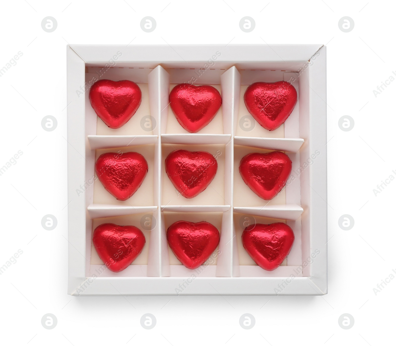 Photo of Heart shaped chocolate candies in box on white background, top view