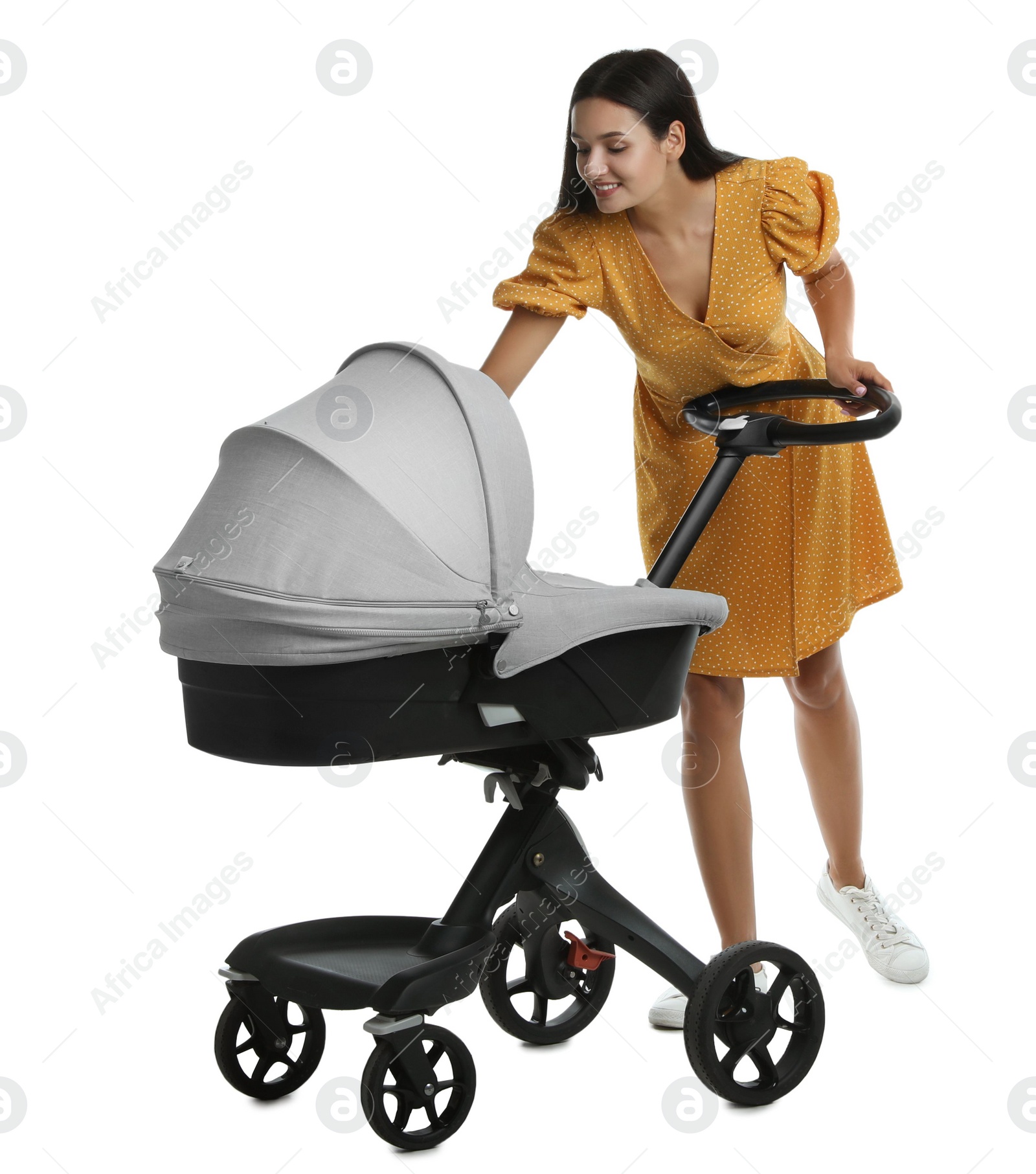 Photo of Happy young woman with baby stroller on white background