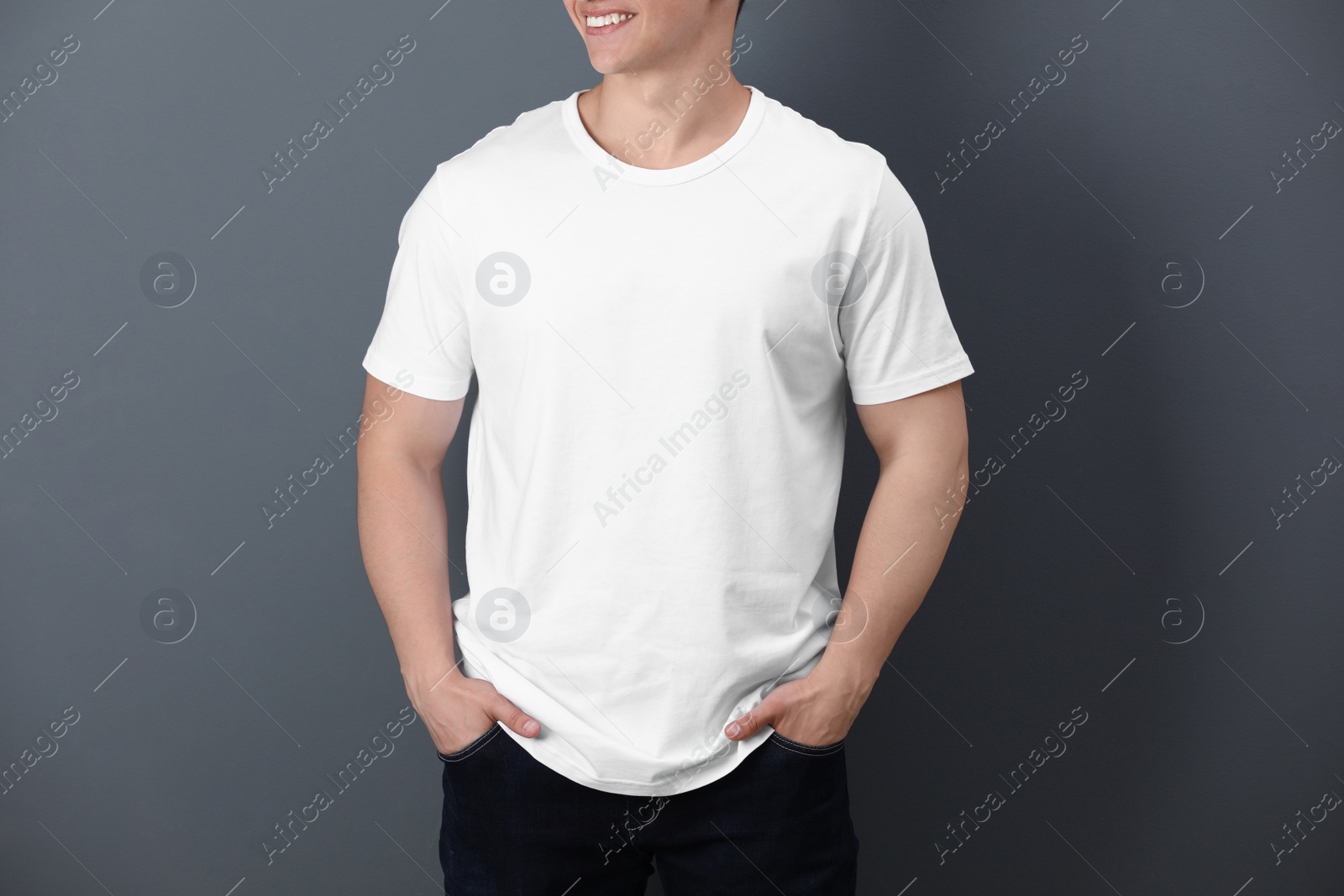 Photo of Young man in white t-shirt on color background. Mockup for design