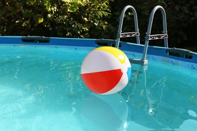 Photo of Inflatable ball on water in above ground swimming pool outdoors